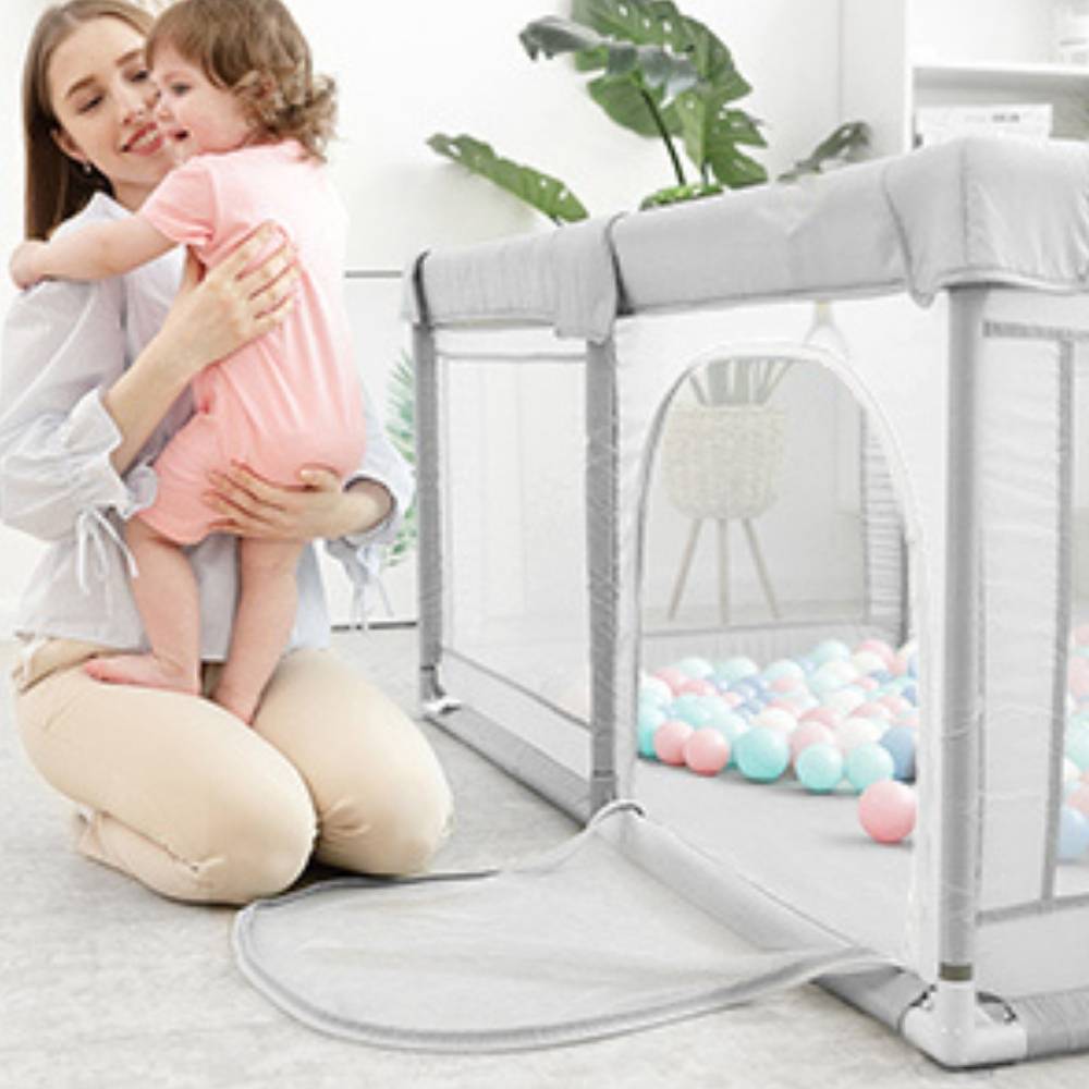 A padded baby play yard with breathable mesh walls